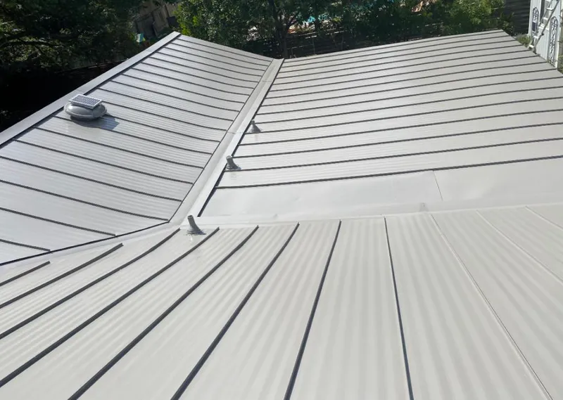 Solar attic fan installed on a metal roof for Roof Ventilation in Bruce